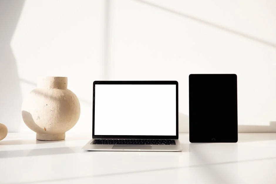 A sleek contemporary tablet showing a search engine logo beside a wireless keyboard resting on a wooden desk.